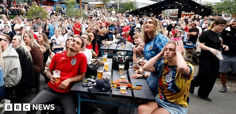 Fans watching football match in crowded outdoor venue