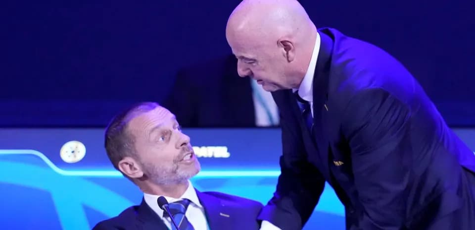 Two officials interacting at a conference table