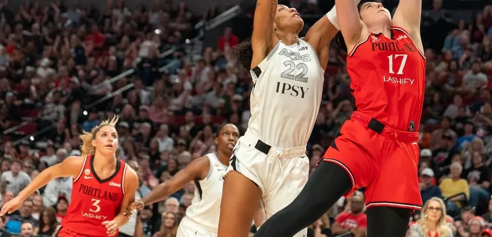 Two players contesting a shot during basketball game