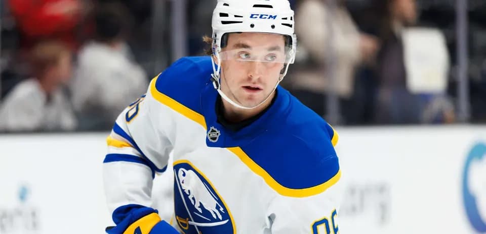 Hockey player in blue and white jersey on ice