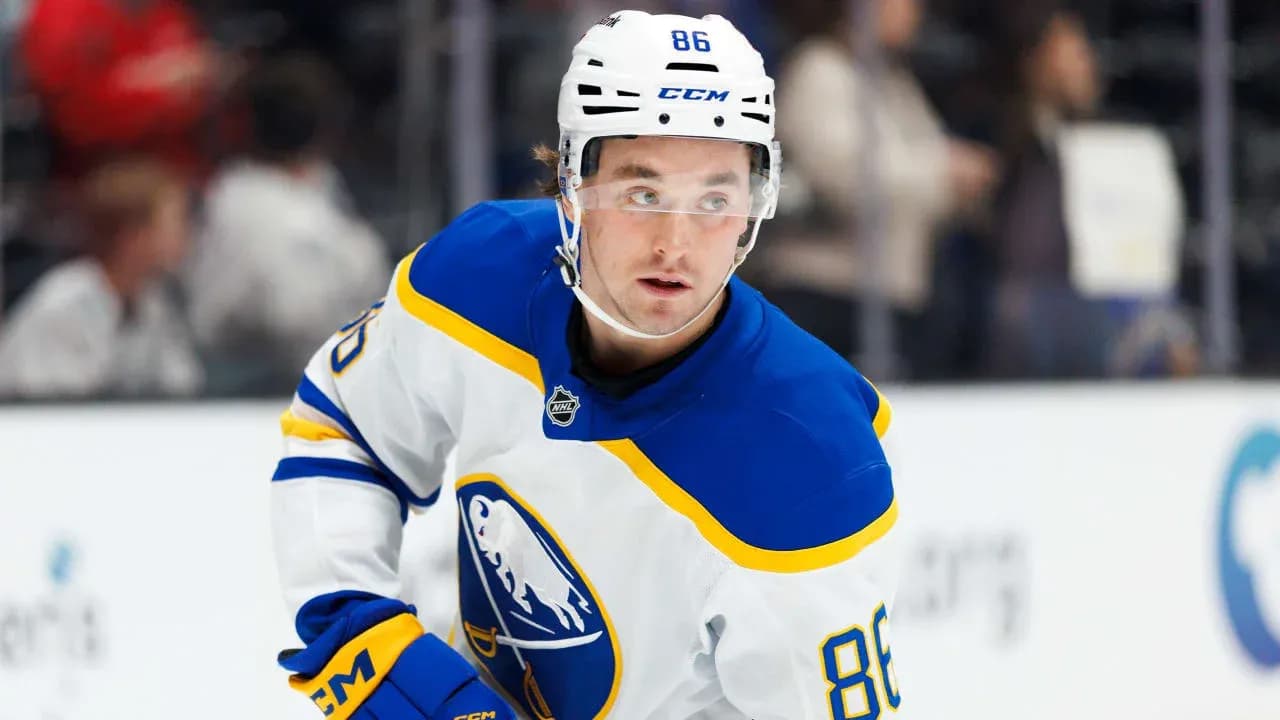Hockey player in blue and white jersey on ice