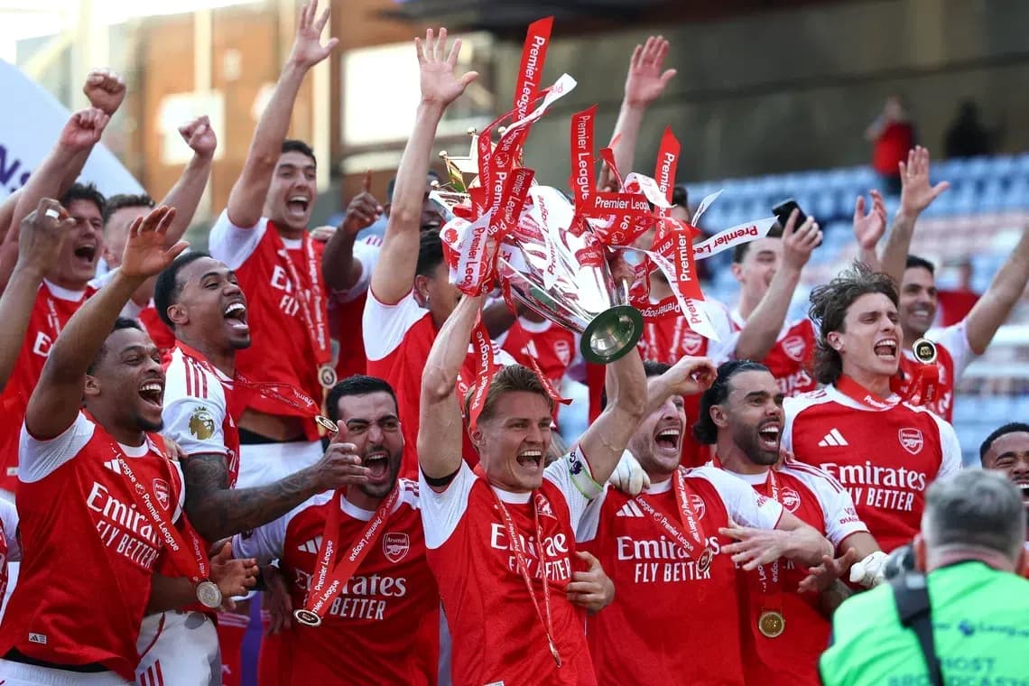 Arsenal players celebrating Premier League trophy victory Arsenal players celebrating Premier League trophy victory