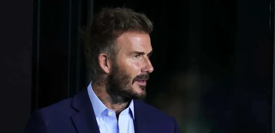 Man with tattoos wearing a suit jacket