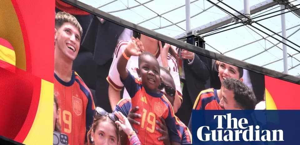 Fans celebrating with a child wearing Spain jersey