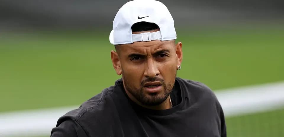 Tennis player wearing cap on training court