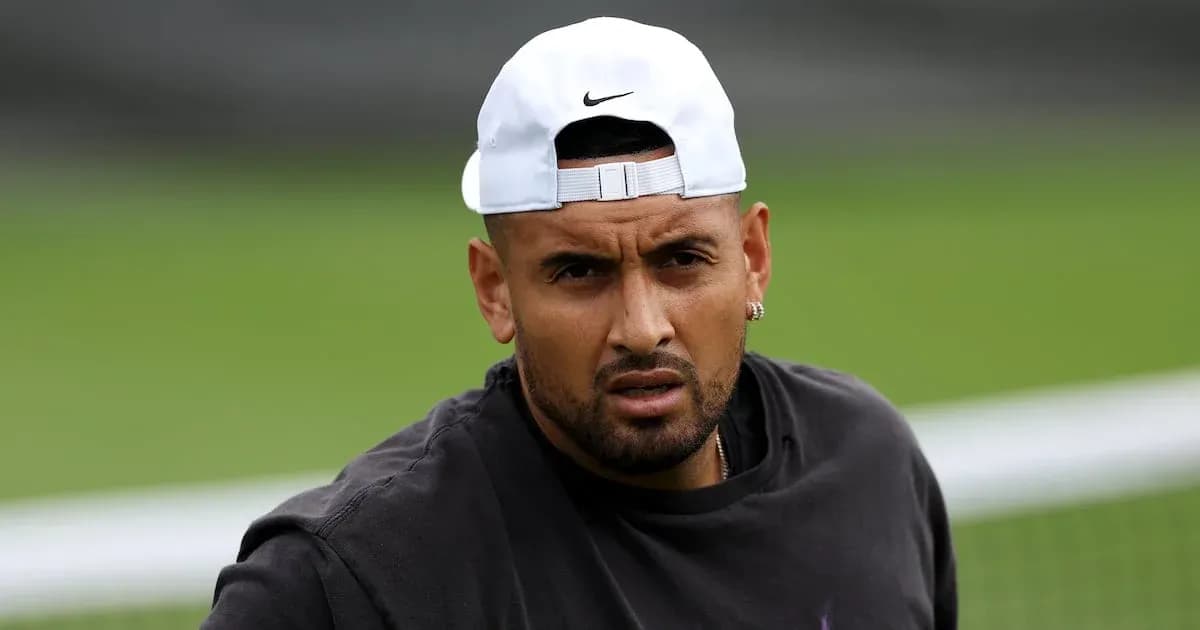 Tennis player wearing cap on training court