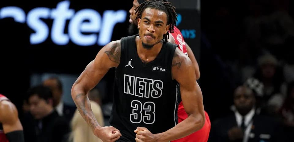 Basketball player celebrating after scoring for Nets