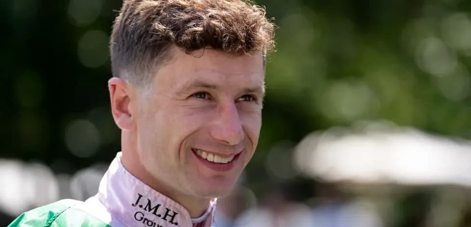 Jockey smiling in racing attire before event