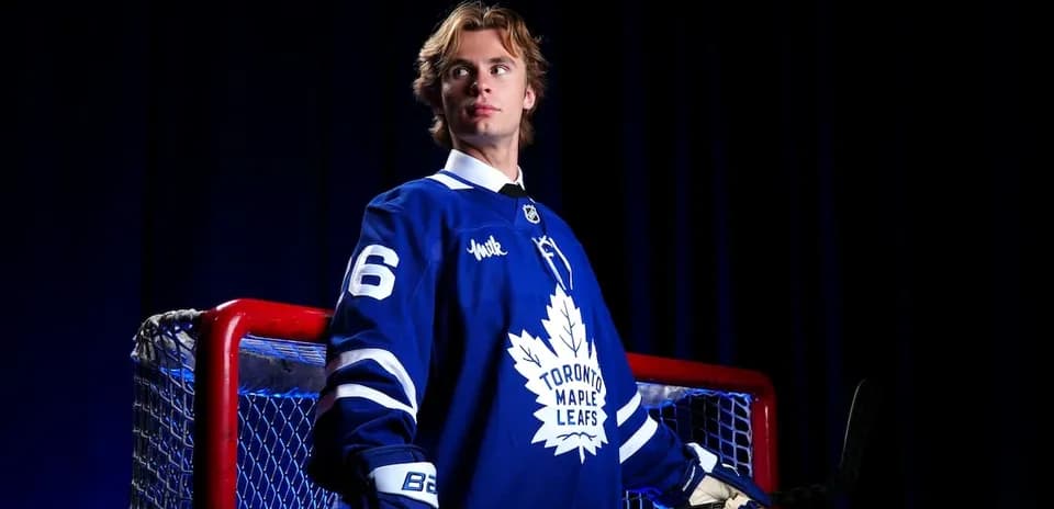 Hockey player in Toronto Maple Leafs jersey by net