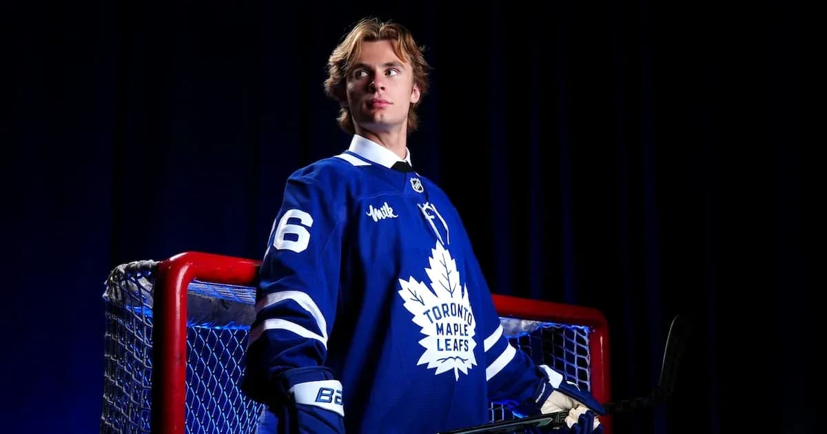 Hockey player in Toronto Maple Leafs jersey by net