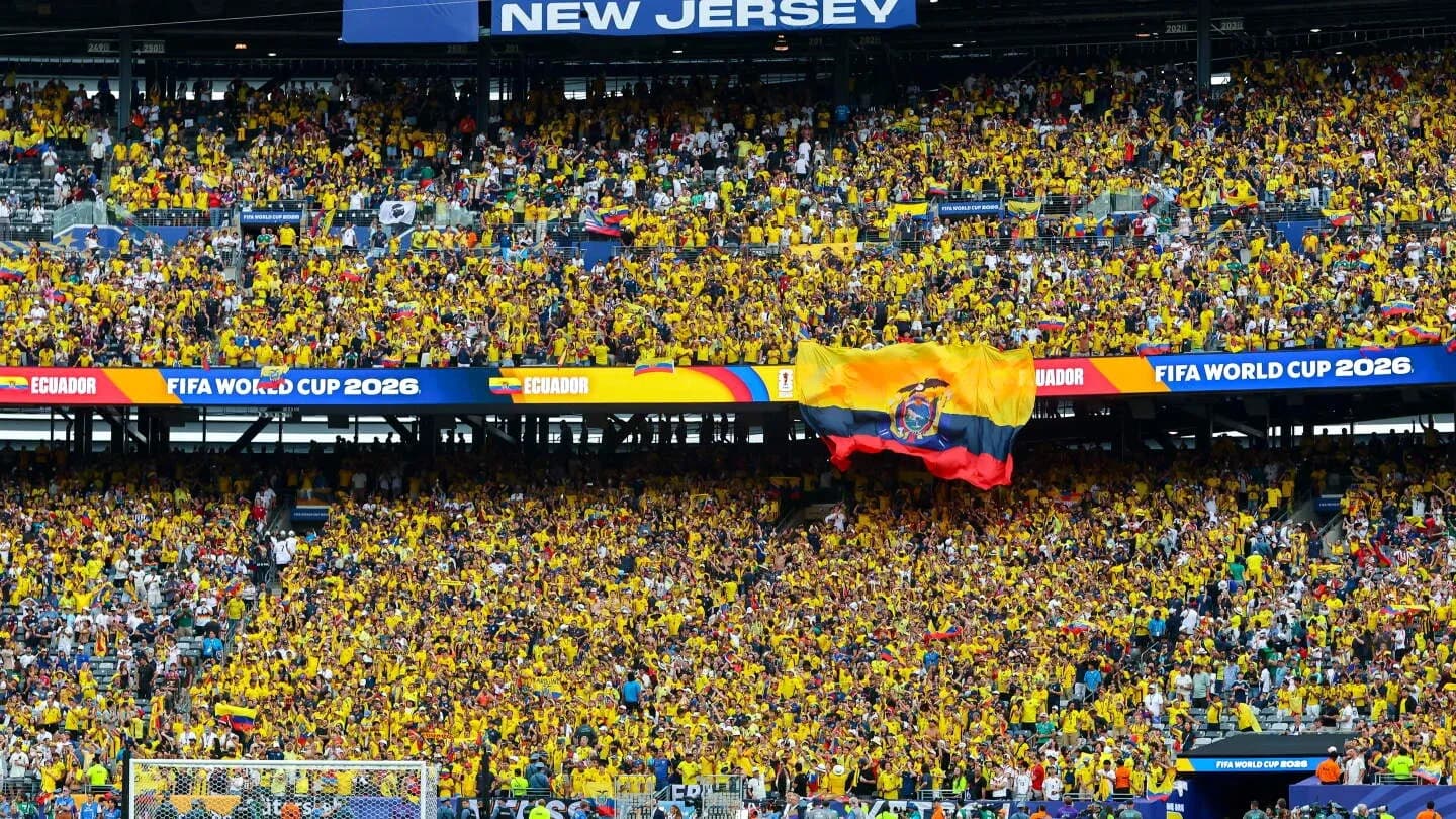 Ecuador fans cheering with yellow shirts at stadium