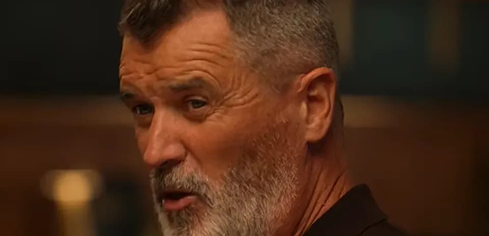 Man with gray beard speaking in a casual setting