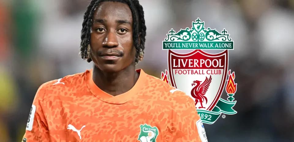 Goalkeeper in orange jersey with Liverpool logo