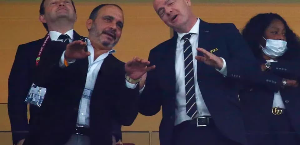 Officials interacting in a stadium box during event