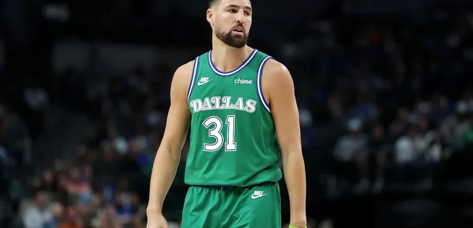 Basketball player in green Dallas jersey on court