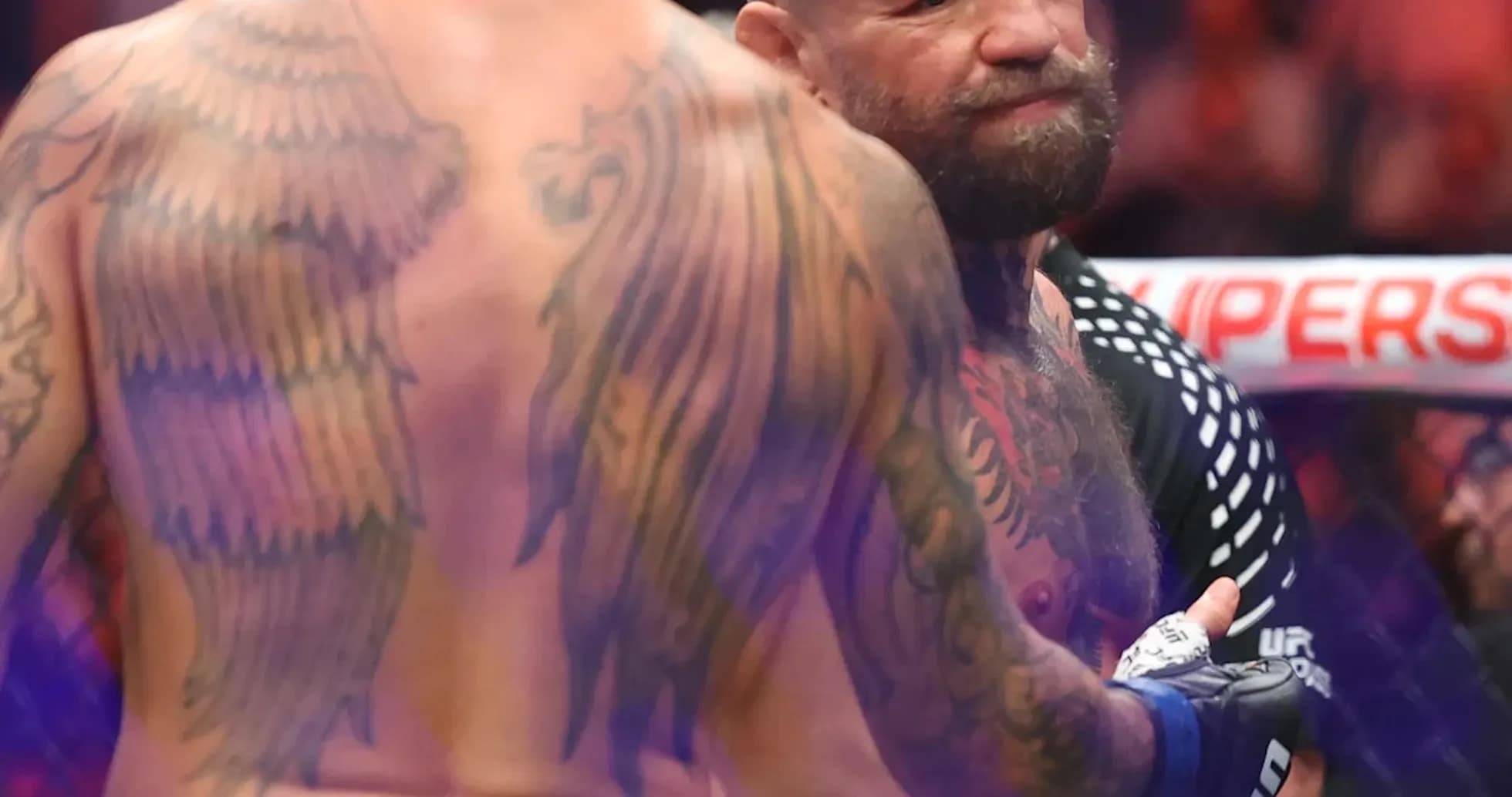 Two fighters facing off in MMA octagon