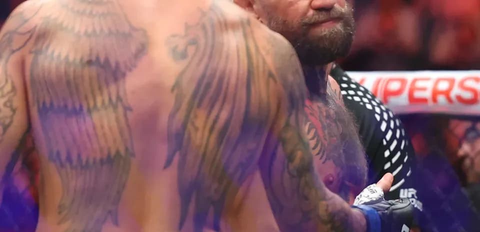 Two fighters facing off in MMA octagon