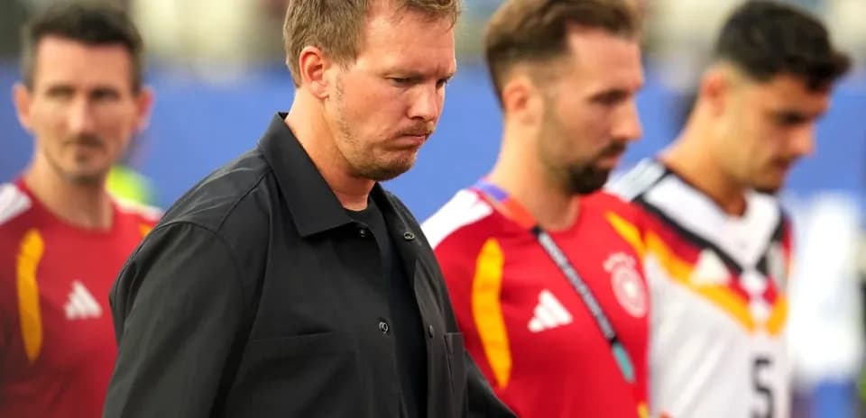 Trio of players walking off the pitch after match