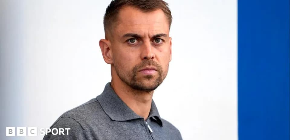 Men's football manager posing for photo