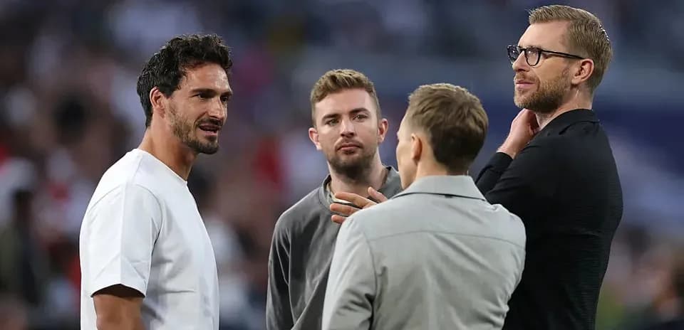 Four men conversing at a sports event