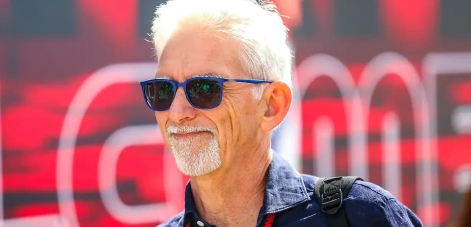 Man wearing sunglasses at a motorsport event