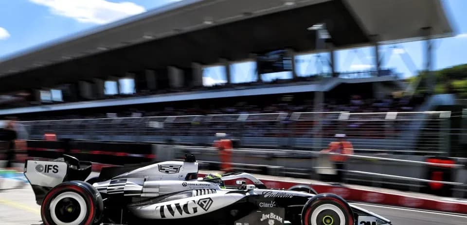 Formula 1 car speeding past pit lane during race