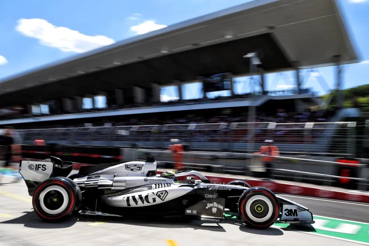 Formula 1 car speeding past pit lane during race Formula 1 car speeding past pit lane during race
