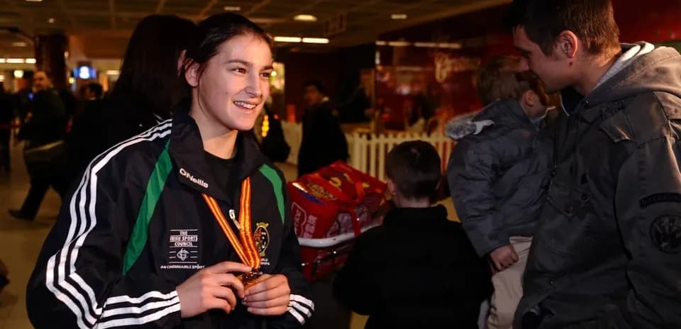Athlete holding medal at an airport event