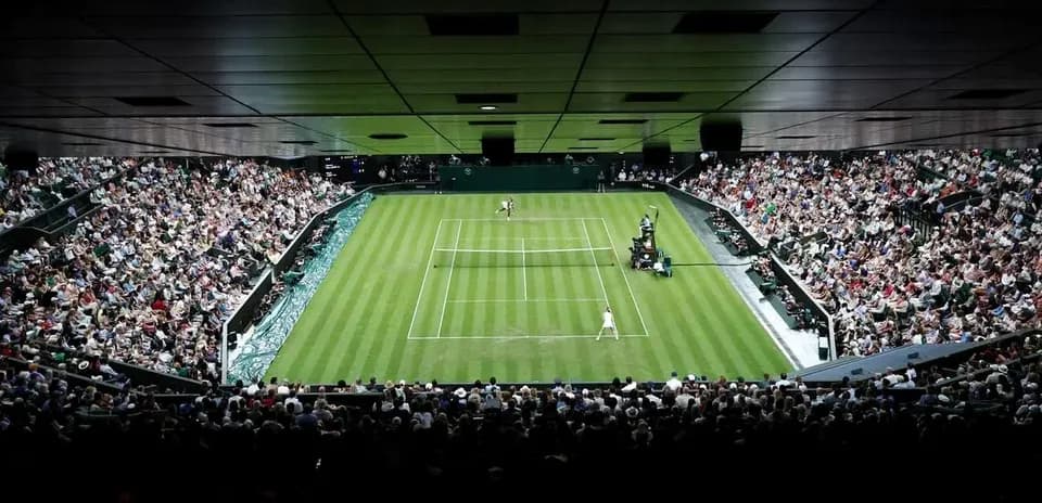 Tennis match in progress at Wimbledon stadium