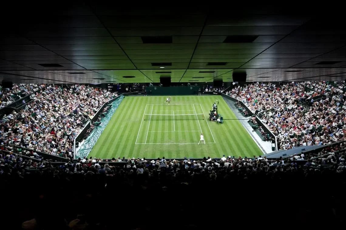 Tennis match in progress at Wimbledon stadium