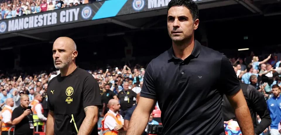 Two football managers walking towards the pitch