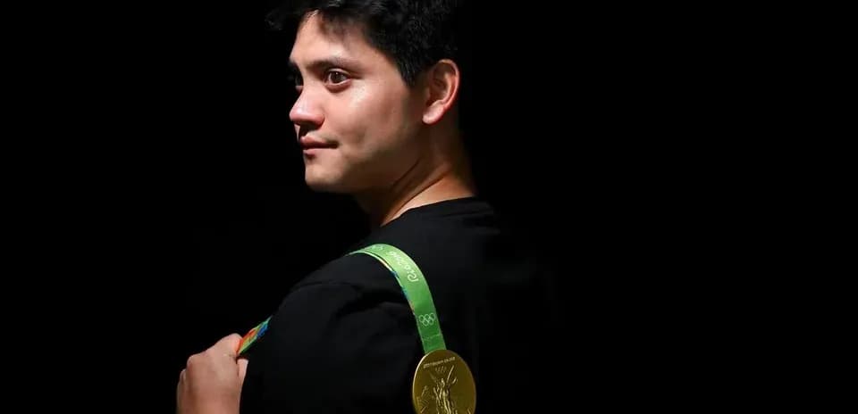 Athlete wearing Olympic gold medal on shoulder