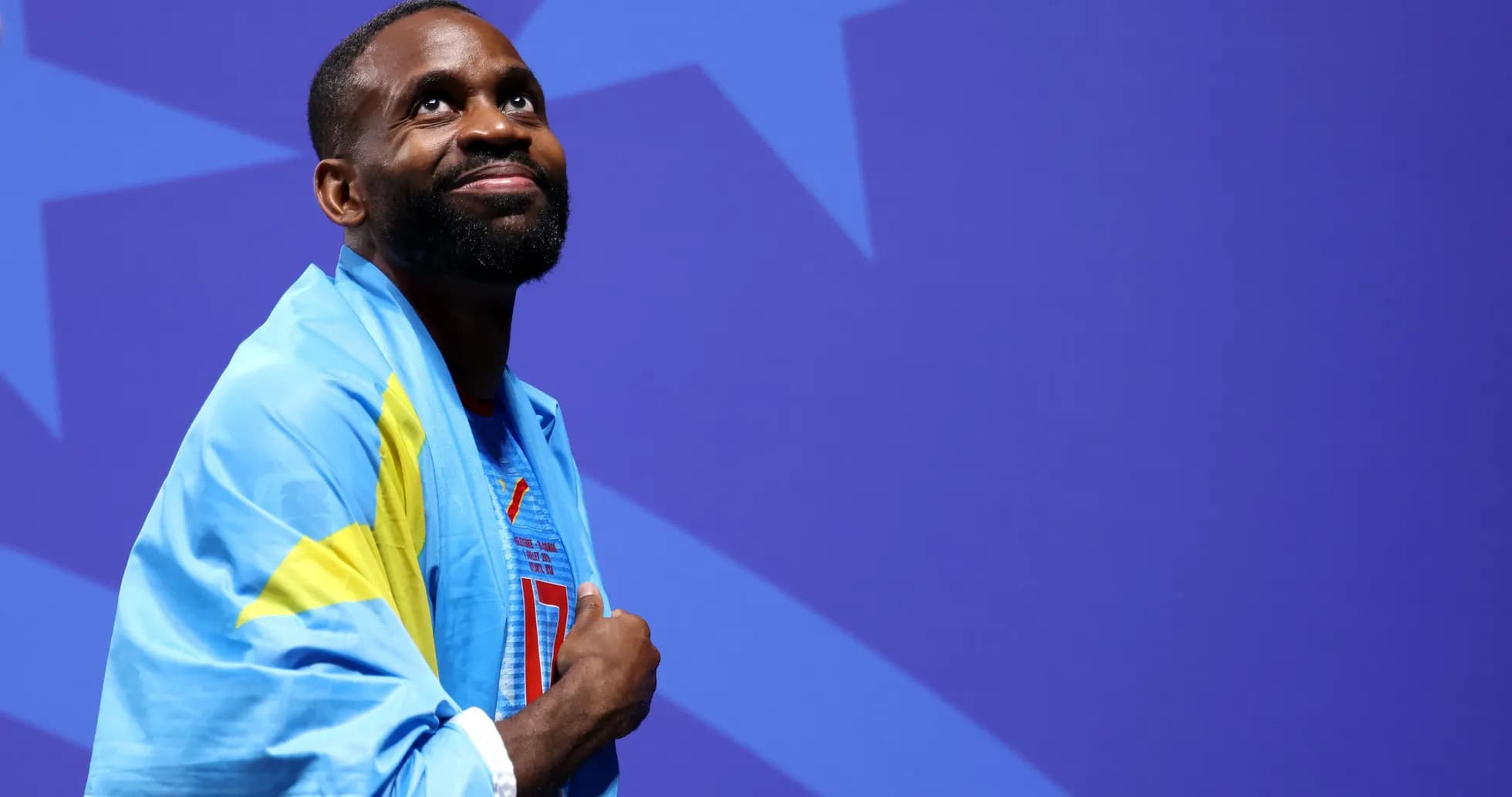 Athlete wearing a flag, looking upward