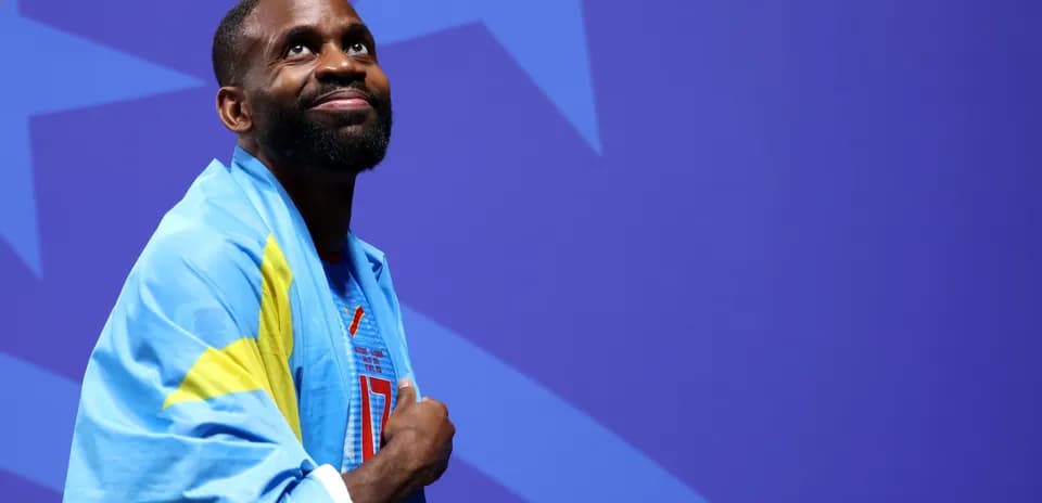 Athlete wearing a flag, looking upward