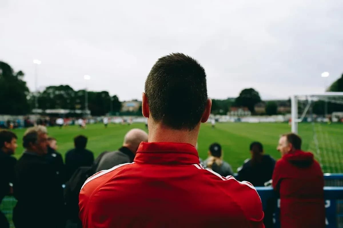 Fan watching football match from the sidelines