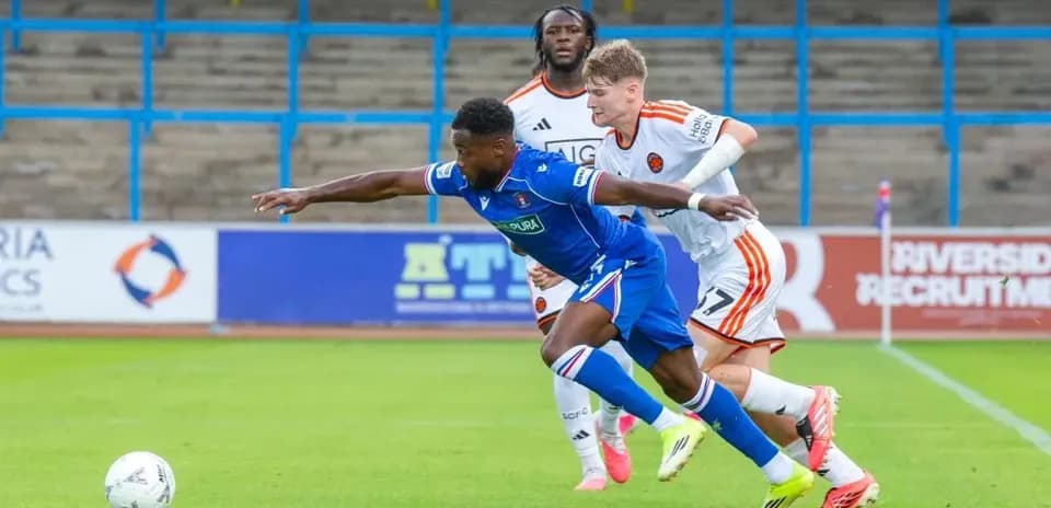 Player tackling opponent during football match action