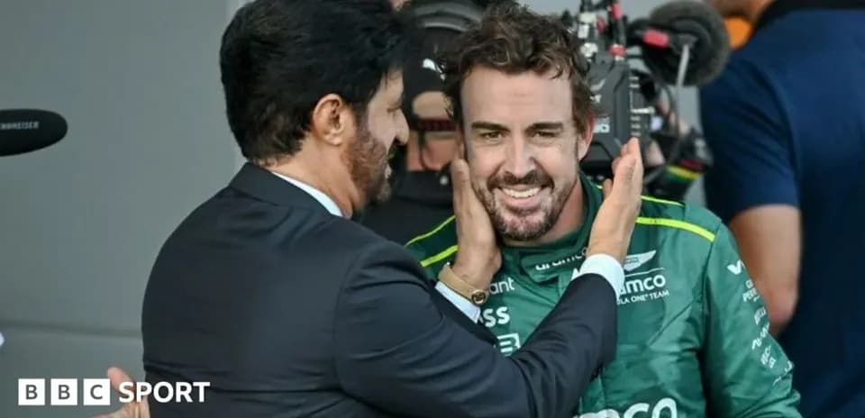 Two men celebrating after a race in the paddock
