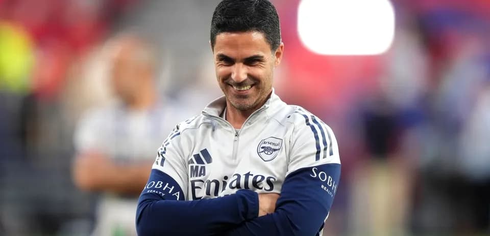 Arsenal coach smiling during match preparations