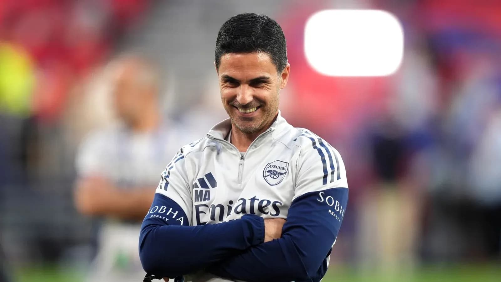 Arsenal coach smiling during match preparations
