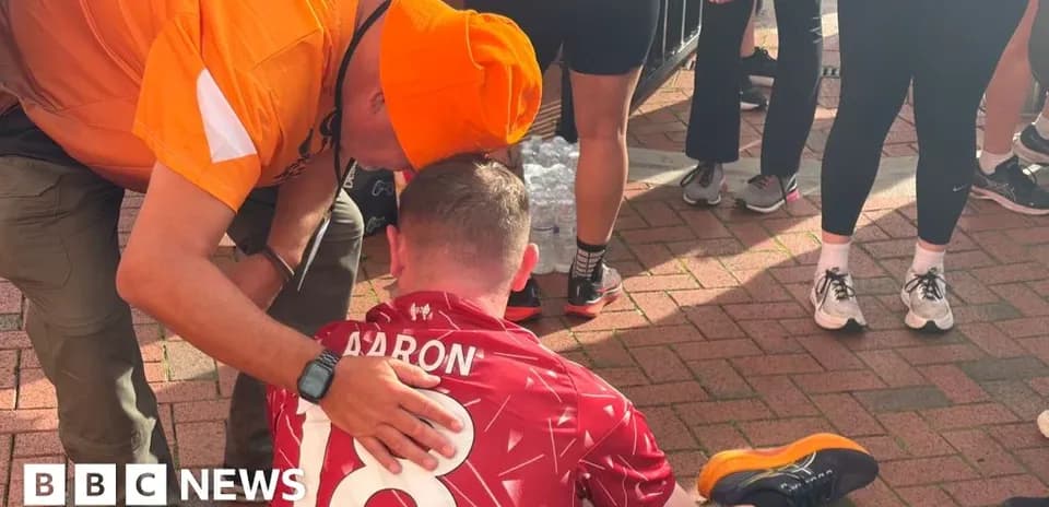 Person assisting another seated athlete after event