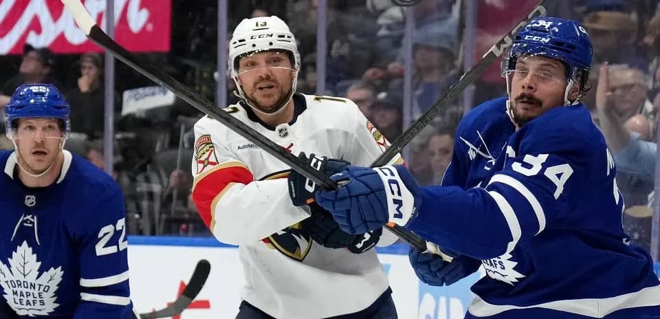 Players battling for puck during hockey match