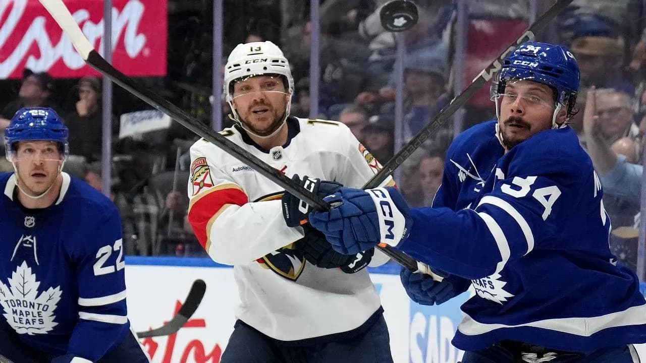 Players battling for puck during hockey match