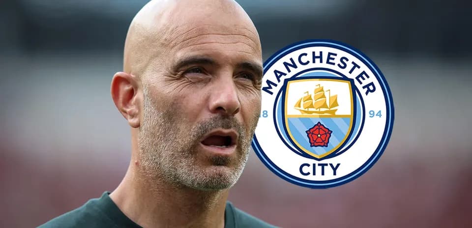 Men coach with Manchester City logo in background