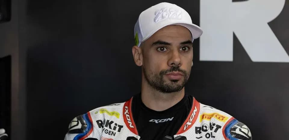 Motorsport athlete wearing racing gear and cap