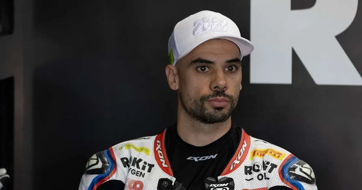Motorsport athlete wearing racing gear and cap