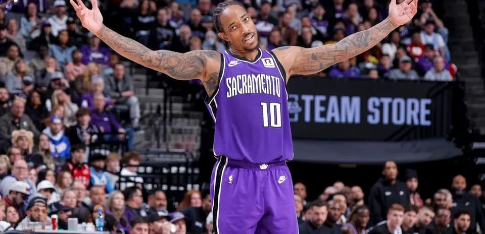 Basketball player gesturing to crowd during game