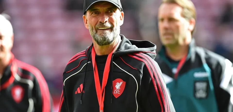 Liverpool manager walking on pitch before match