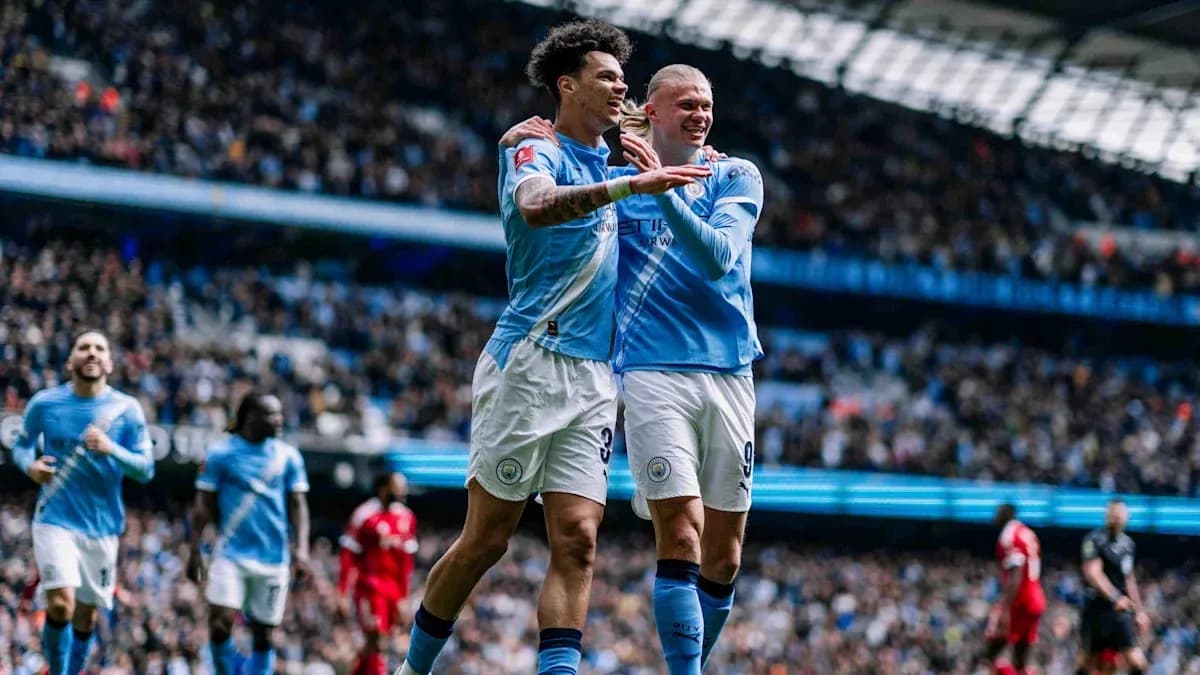 Manchester City players celebrating a goal on pitch