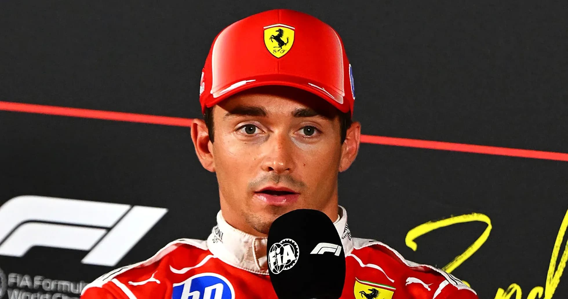 F1 driver speaking at press conference with microphone