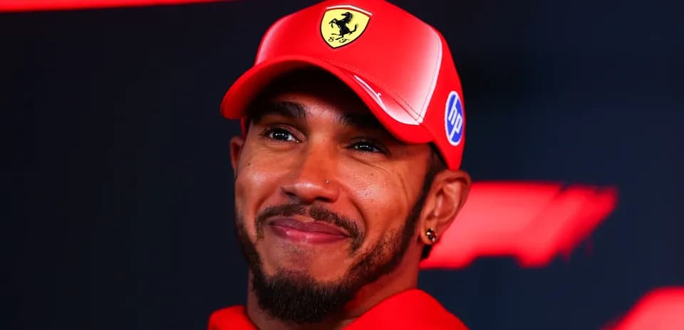 Driver wearing Ferrari cap at press event